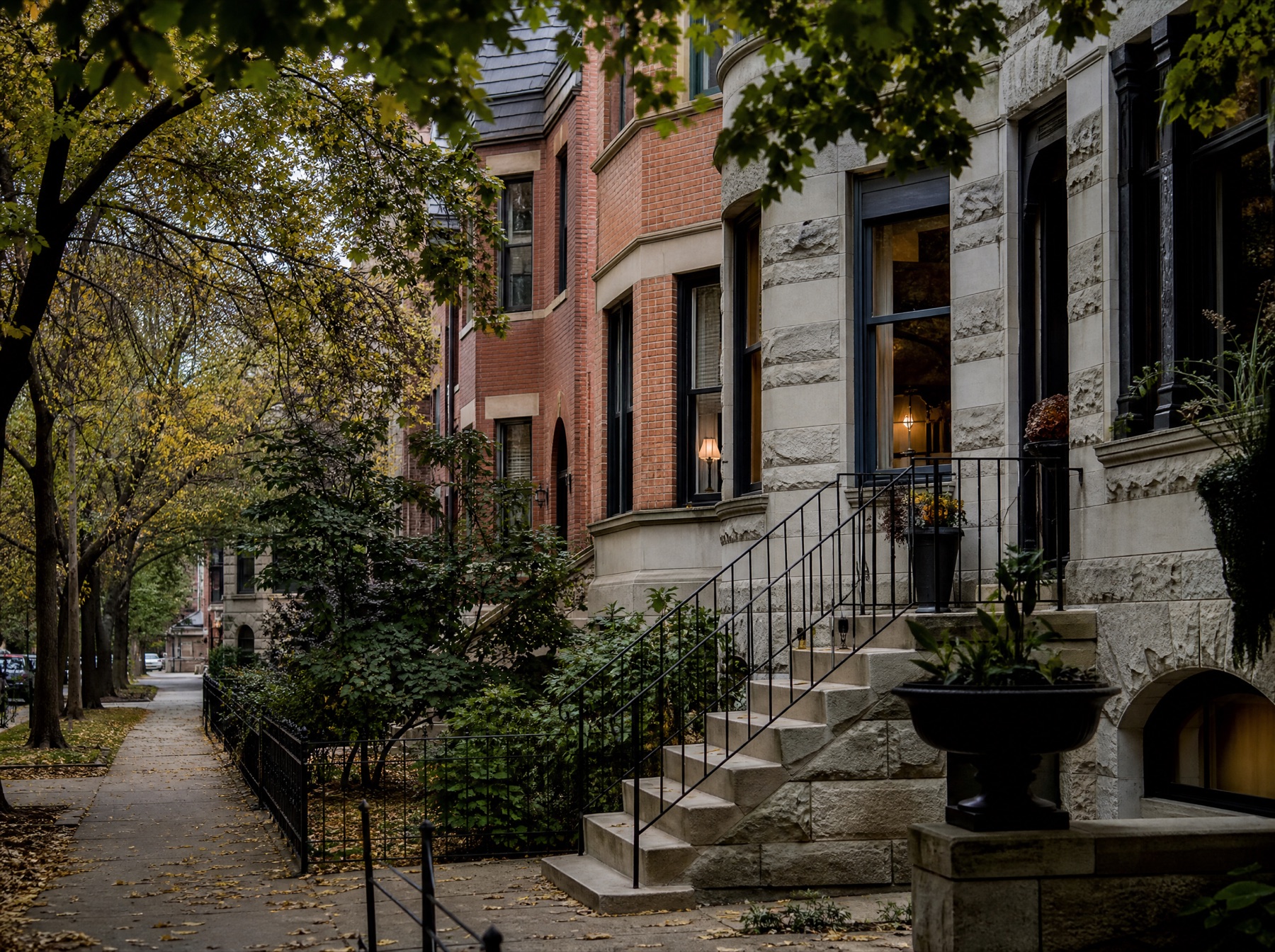 Tree-lined Chicago residential street with historic brick and stone row houses